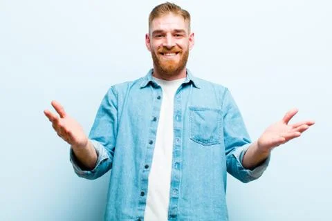 Young red head man feeling happy, astonished, lucky and surprised, like sayin Stock Photos