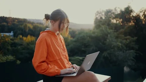 The young redhead looks to one side, is inspired by nature, then continues to Stock Footage 159572535