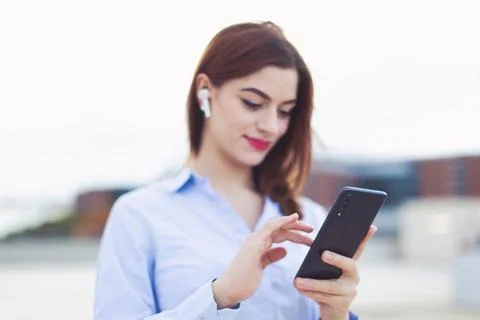 Young redhead manager using mobile phone outdoors Stock Photos