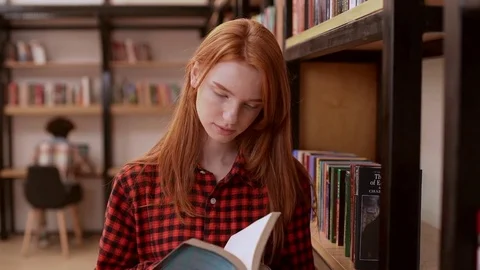 Young redhead teenage girl in red shirt ... | Stock Video