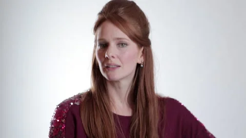 A young redheaded comedian making funny faces against a white background. Video stock 191346853