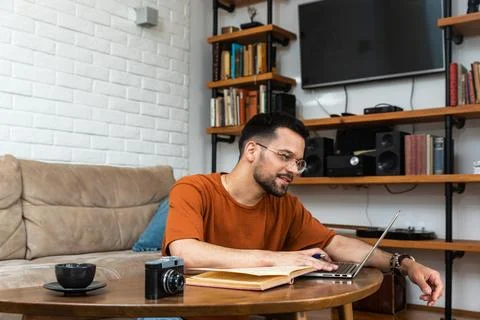 Young religious man found an old book about buddhism or hinduism and religi.. Stock Photos
