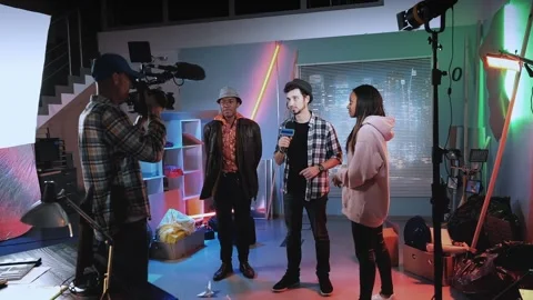 Young reporter taking interview for mass media with stars of the new movie Stock Footage 130663651