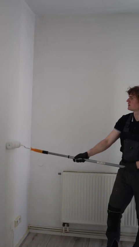 Young resident paints walls in first apartment Stock Footage 334592680
