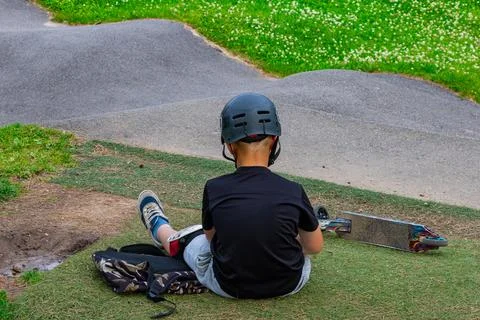 Young Rider Resting At Pump Track With Scooter Fotos de archivo