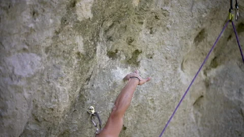Young rock climber checking grip in climbing socket for safety 動画素材 131838368