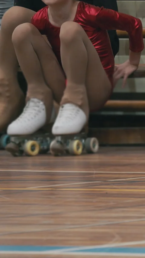 Young roller skaters training on a wooden rink floor Stock Footage 327876123