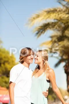 Young Romantic Beautiful Couple Enjoying On A Walkside