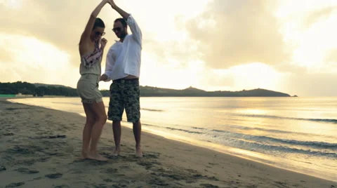 Young romantic couple dance at sunset on shore in summer outdoor Stock-Footage 64560191