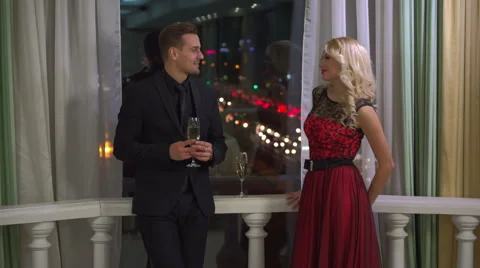 Young romantic couple evening date flirt drink glass of champaign at restaurant Stock Footage 60055511