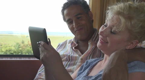 Young romantic couple play digital tablet computer train electronic touchscreen Stock Footage 28696210