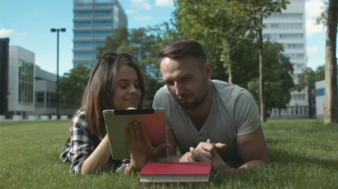 Young romantic couple spending time in park with tablet. Stock Footage 55078503
