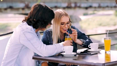 Young romantic couple spending time together - sitting in cafe's garden Stock Footage 89825436
