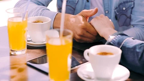Young romantic couple spending time together - sitting in cafe's garden Stock Footage 89825437