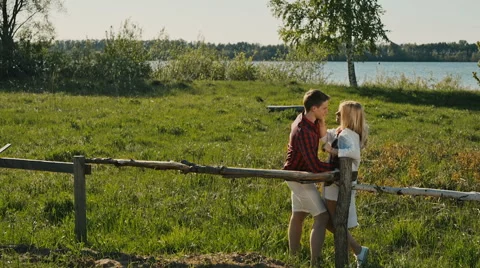 Young romantic couple standing on the river bank 動画素材 63301562