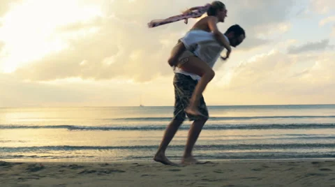 Young romantic couple walk at sunset on shore in summer outdoor 動画素材 64560232