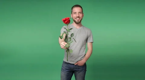 Young romantic man giving a red rose Stock Footage 69070484