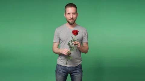 Young romantic man with a red rose Stock Footage 69070455