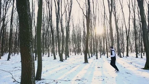 Young runner run in morning cold winter forest. Athlete during training. Dense Stockbeeldmateriaal 76193518