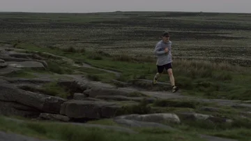 Young runner running along Stanage edge trail run in Peak district  Stock Footage 85659522