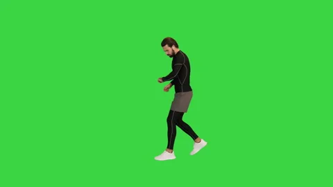 Young Runner Stops Tired Taking A Break on a Green Screen, Chroma Key. Stock Footage 157328448
