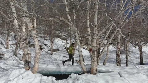 Young runner in winter jogging in park Stock Footage 124363542