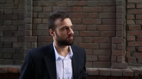 Young Sad Man Looking Camera Presentation Posing Serious Look Red Bricks Wall Stock Footage 77015893