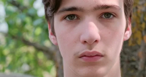 Young sad man looks on the camera. Unhappy alone young teenager, outdoors. Cl Stock Footage 139254780