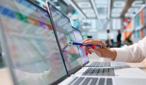 Young Sales Manager Analyzes Customer Data On Laptop For Better Marketing. Stock Photos