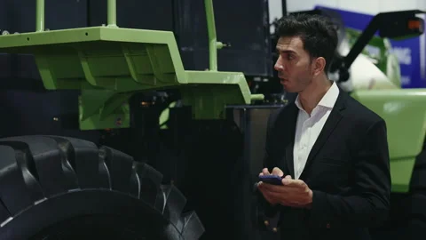 Young Salesman Checking the Tractor and Thinking About Transport Condition. Stock Footage 264339613