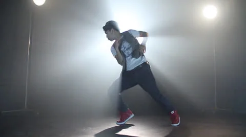 Young  sassy guy makes Jazz hops in a bright white light excellently Stockbeeldmateriaal 22844819