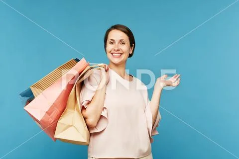 Young satisfied shopaholic with several paperbags Stock Photos