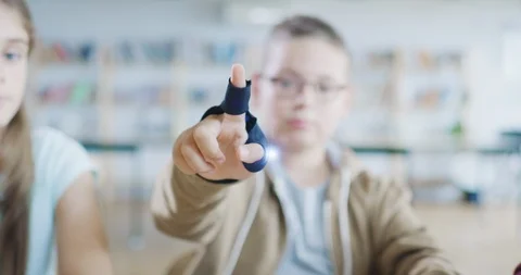 Young School Kid Using High Tech Gloves Interactive VR Lesson In A Technology Stock Footage 100736196