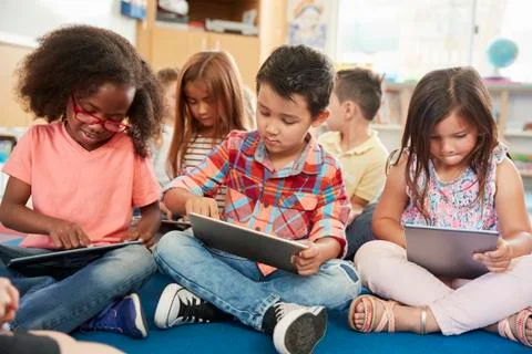 Young school kids in class using tablet computers, close up Foto stock