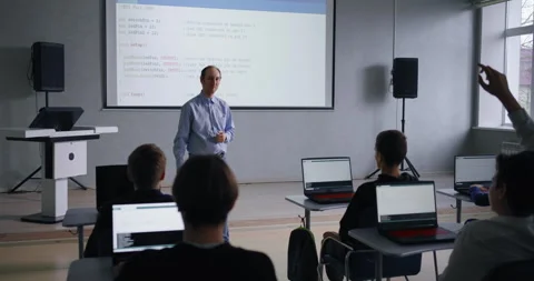 Young School Students Asking Middle-Aged Teacher, Group Of Pupils Studying Stock Footage 283297800