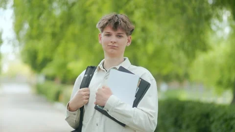 Young Schoolboy with Neutral Expression in Outdoor School Scene Stock Footage 310882581