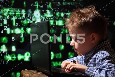 Young schoolboy prodigy - a hacker. Hacker at work. Stock Image #74448511