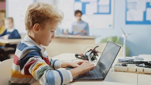 Young Schoolboy Uses Laptop to Program Software for Robotics Engineering Class. Stock Footage 119561262