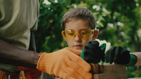 Young schooler removes rough surface on wood using plane Stock Footage 198382943