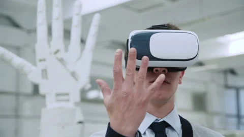 Young scientist controls robotic arm through virtual reality glasses Video stock 91352717