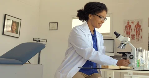 Young scientist examines a sample through a microscope. Stock-Footage 88371885