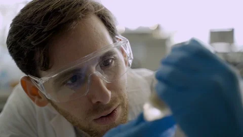 Young scientist or student amazed at a result of an experiment in a lab Stock Footage 112596815
