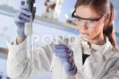 Young scientist pipetting in life science laboratory Stock Photos
