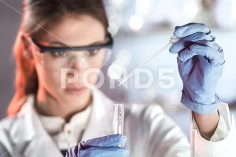 Young scientist pipetting in life science laboratory. Stock Photos