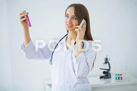 Young scientist pipetting in life science laboratory. Stock Photos