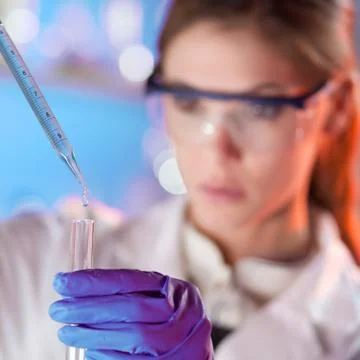 Young scientist pipetting. Stock Photos