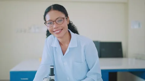 Young scientist smiles warmly in lab setting Stock Footage 338011209