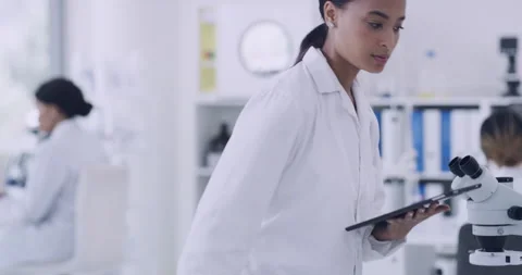 Young scientist using a digital tablet and computer in a lab. Dedicated woman 스톡 동영상 200794015