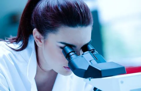 Young scientist using a microscope Stock Photos