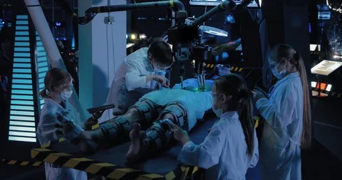 Young scientists make an autopsy of an alien, take a sample of the material Stock Footage 102983754